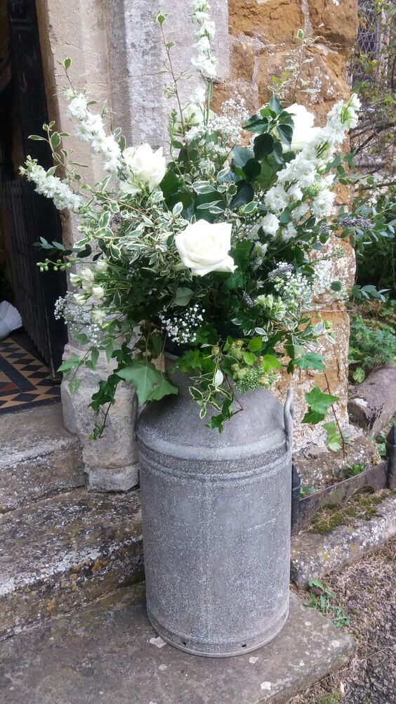Rustic cream milk churn flower arrangement
